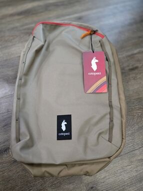 Cotopaxi Men’s Travel Backpack in Tan with Red Accent